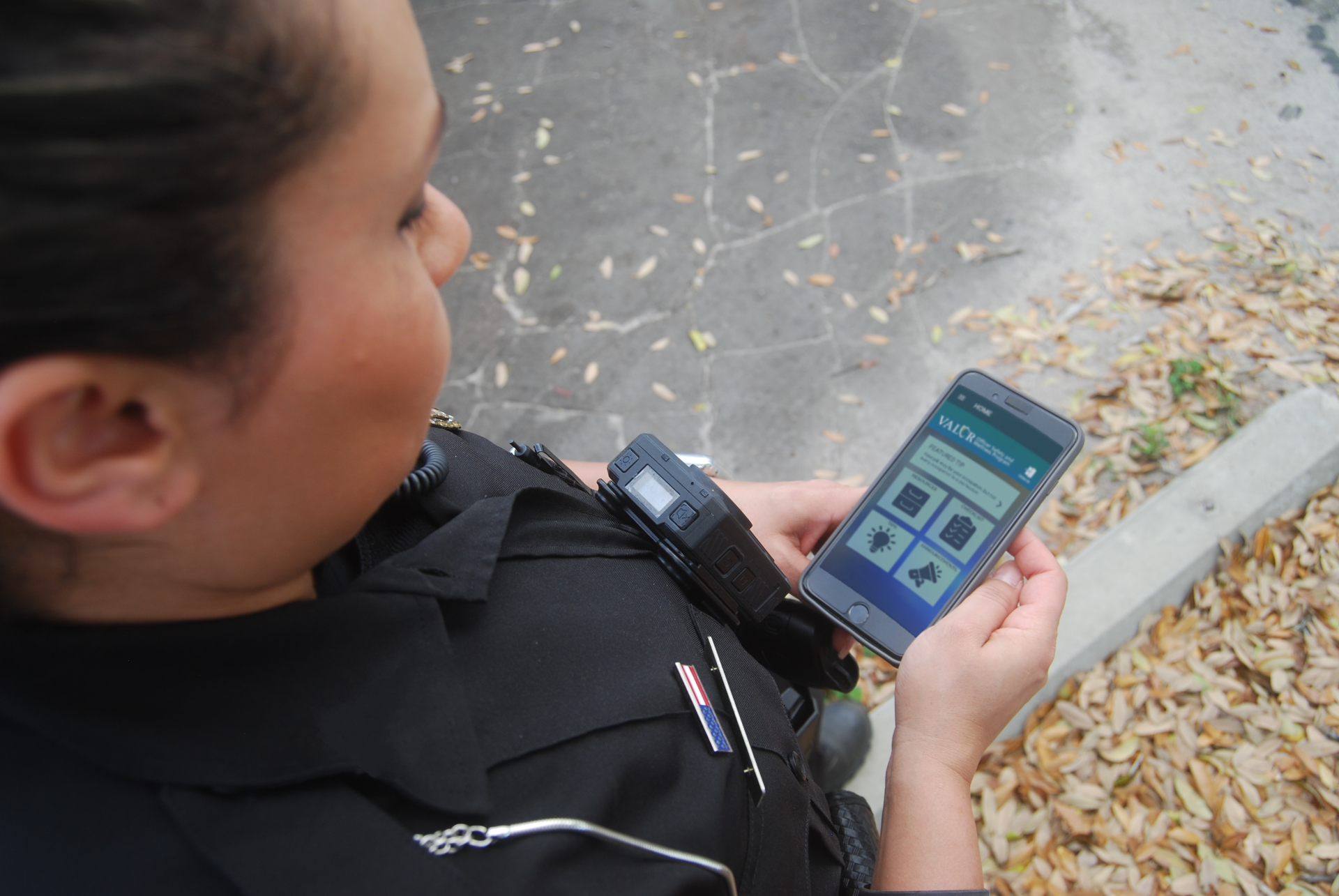 Police officer holding a cell phone